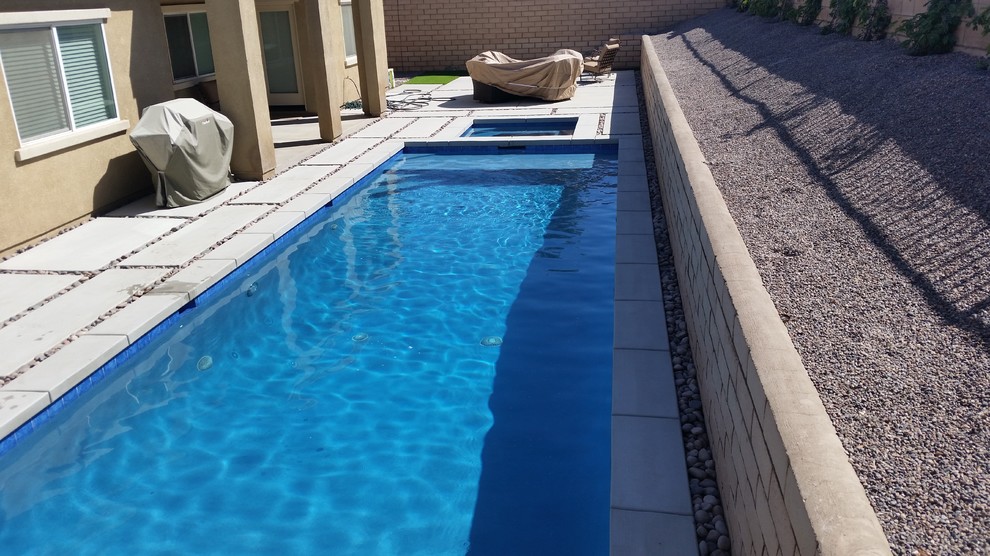 Design ideas for a medium sized modern back rectangular lengths swimming pool in Other with concrete slabs.