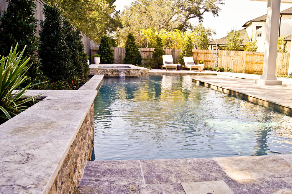 Small minimalist backyard stone and kidney-shaped hot tub photo in Houston