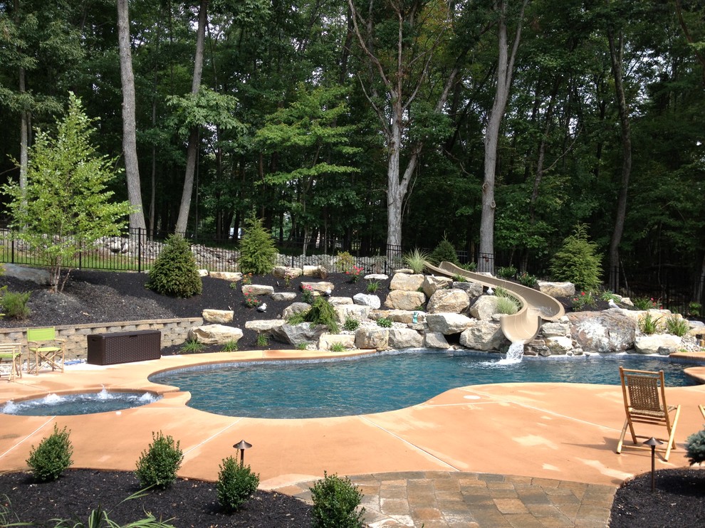 Elegant backyard custom-shaped natural hot tub photo in Philadelphia with decking