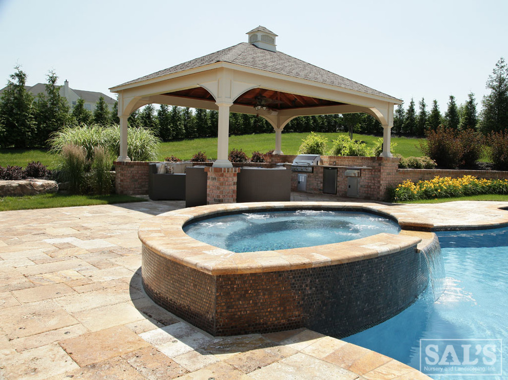 Design ideas for a large classic back custom shaped hot tub in Philadelphia with brick paving.