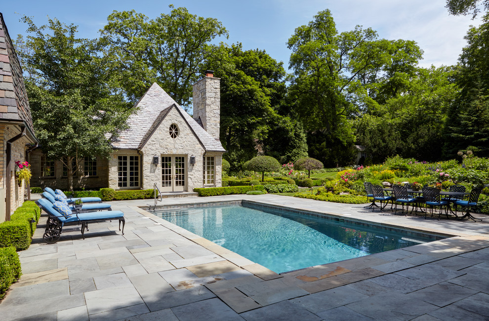 Inspiration for a medium sized classic back rectangular lengths swimming pool in Chicago with a pool house and concrete paving.