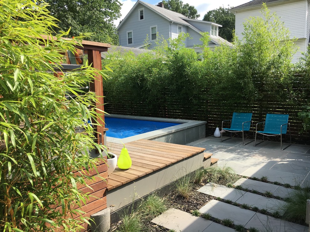 Idee per una grande piscina moderna dietro casa con pavimentazioni in pietra naturale
