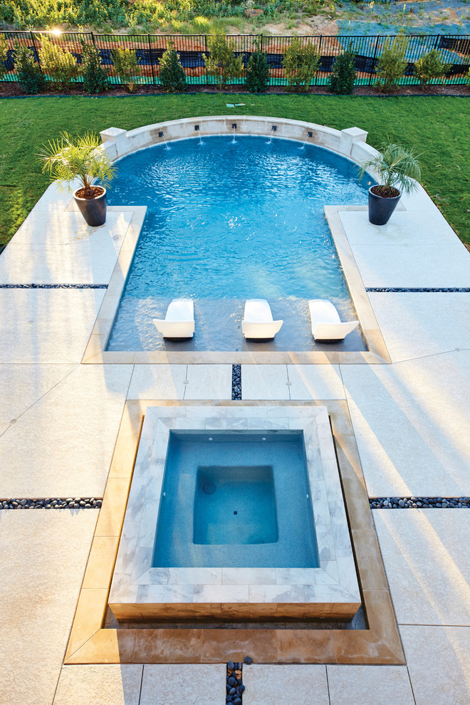 Modelo de piscinas y jacuzzis contemporáneos grandes a medida en patio trasero con suelo de hormigón estampado