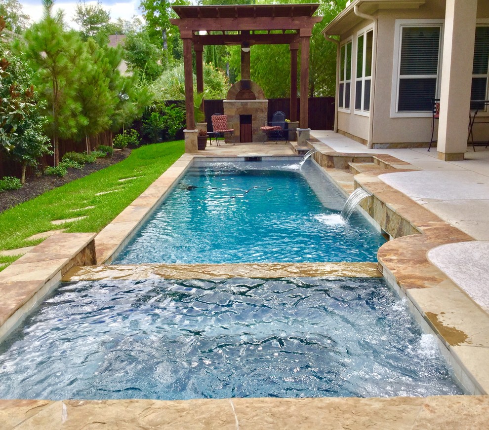 Inspiration for a mid-sized timeless backyard stone and rectangular lap hot tub remodel in Houston