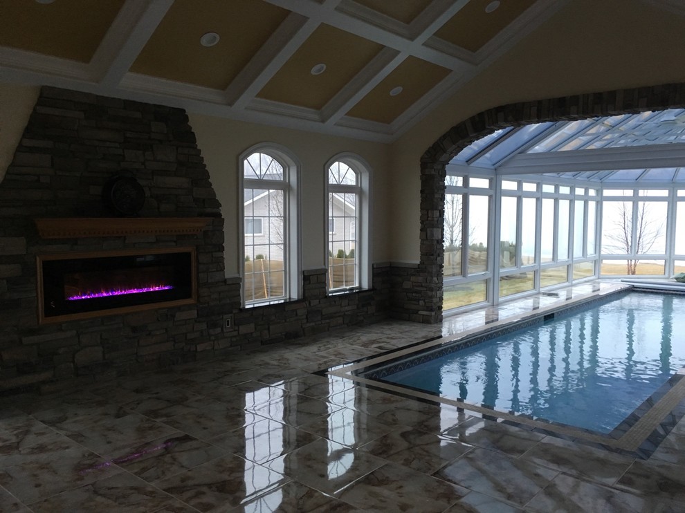 Ejemplo de piscina alargada tradicional renovada grande interior y rectangular con suelo de baldosas