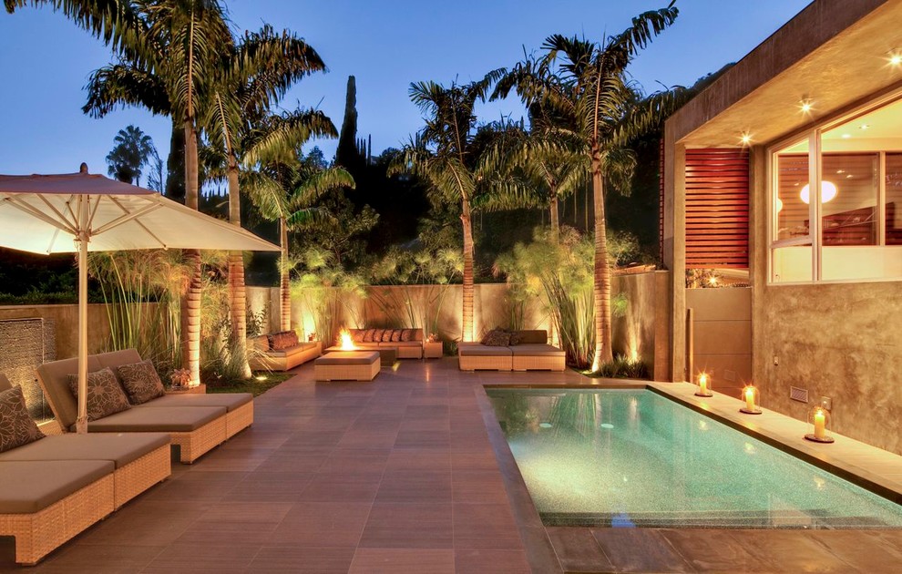 Inspiration for a mid-sized contemporary backyard concrete and rectangular infinity pool fountain remodel in Los Angeles