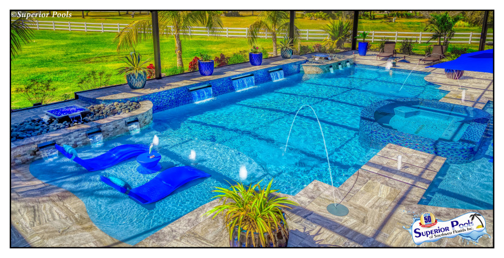 This is an example of an expansive world-inspired back custom shaped swimming pool in Tampa with decking.