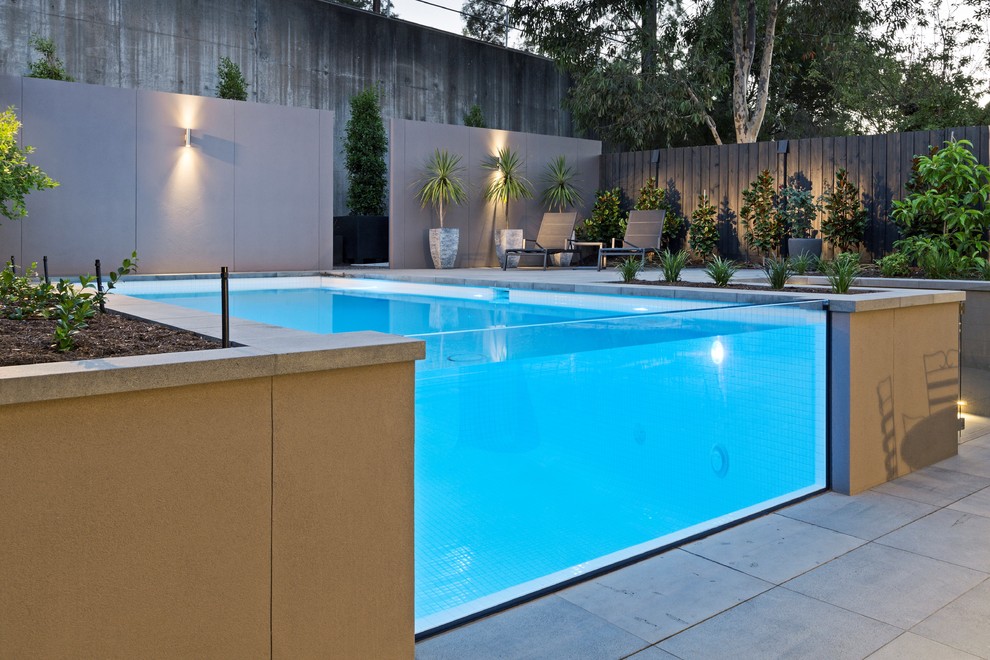 Example of a mid-sized minimalist backyard stone and rectangular aboveground pool design in Melbourne