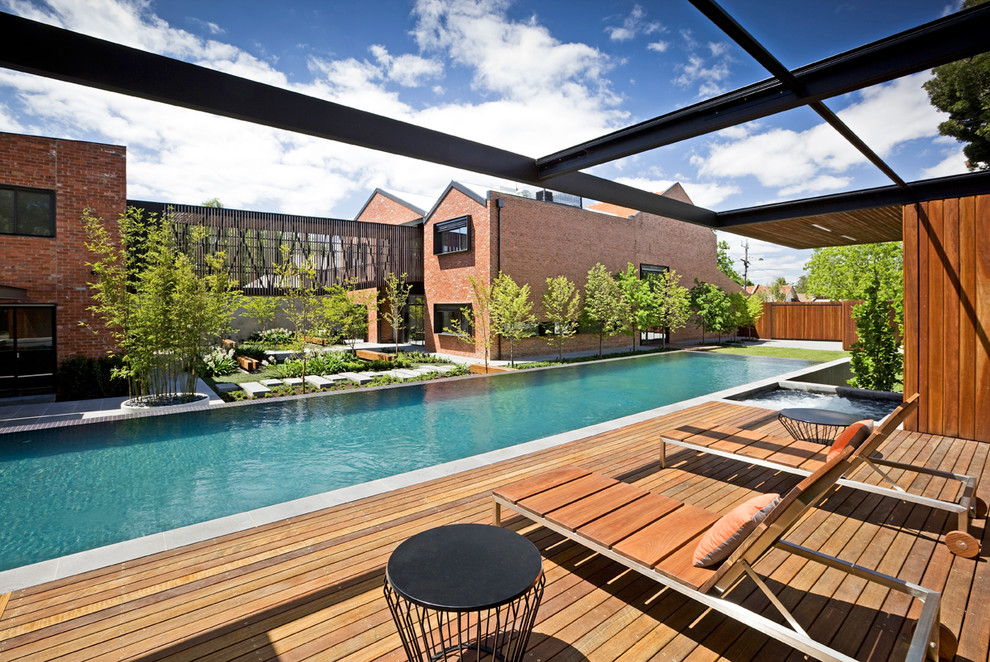 Large trendy backyard rectangular lap pool photo in Melbourne with decking
