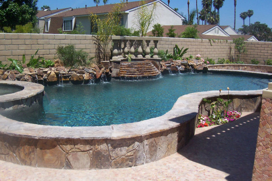 Mid-sized elegant backyard stamped concrete and kidney-shaped lap hot tub photo in Orange County