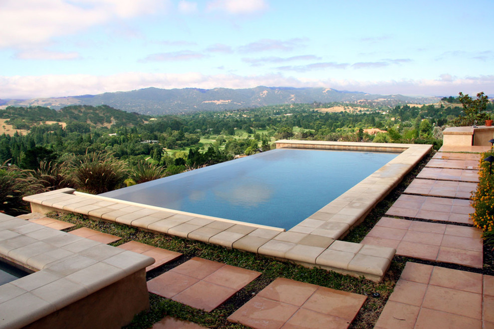 Inspiration for a large mediterranean backyard tile and rectangular infinity hot tub remodel in San Francisco