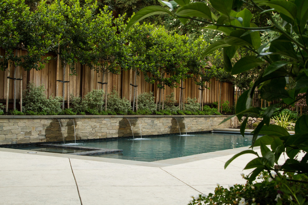 Inspiration for a large modern backyard stamped concrete and rectangular lap pool fountain remodel in San Francisco