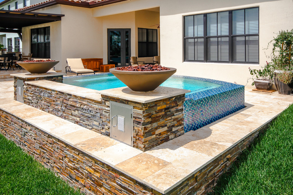 Idee per una piccola piscina fuori terra minimalista personalizzata dietro casa con una vasca idromassaggio e pavimentazioni in pietra naturale