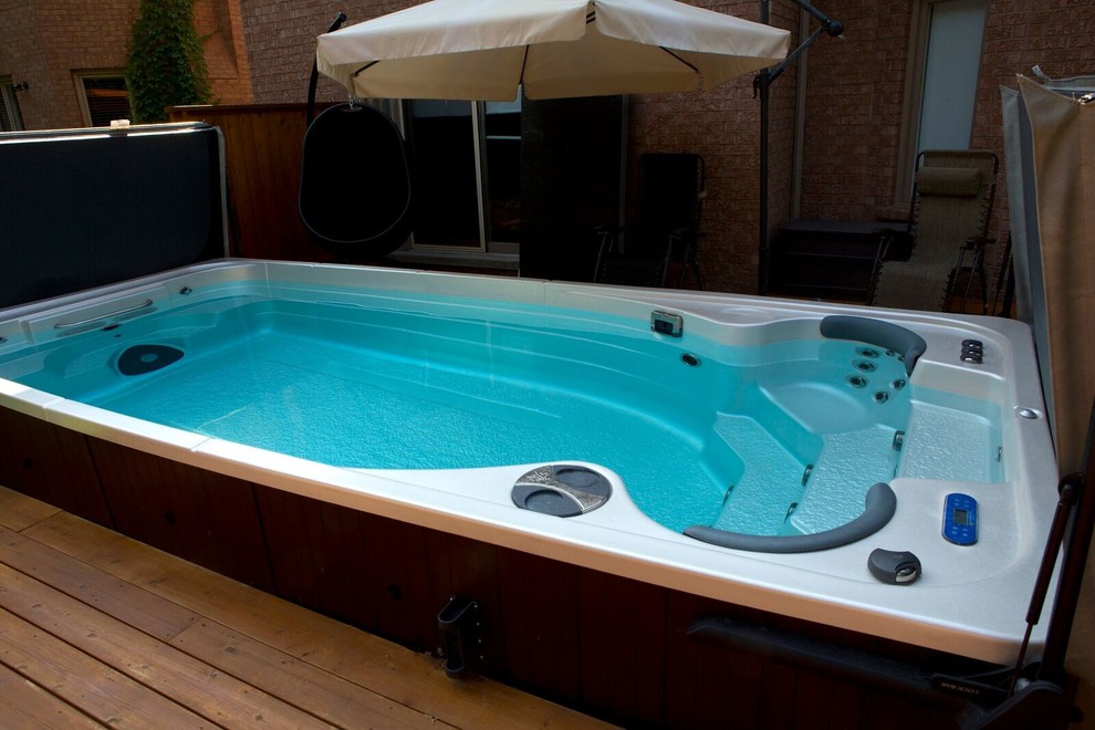 Example of a mid-sized classic backyard stone and rectangular lap hot tub design in Phoenix