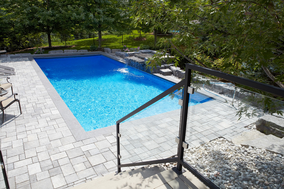 Design ideas for a medium sized contemporary back rectangular lengths hot tub in Toronto with concrete paving.