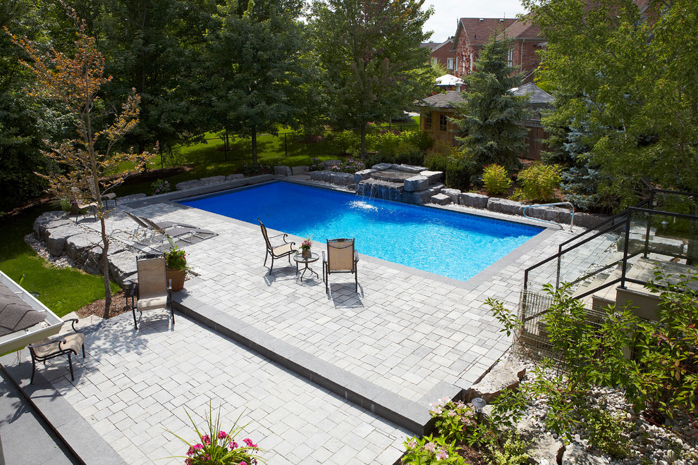 Hot tub - mid-sized contemporary backyard concrete paver and rectangular lap hot tub idea in Toronto