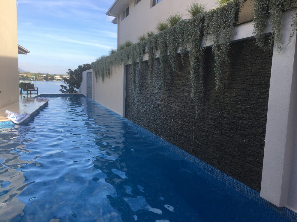 Pool - contemporary backyard tile lap pool idea in Sunshine Coast