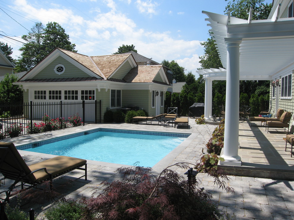 Medium sized traditional back rectangular lengths swimming pool in New York with natural stone paving.