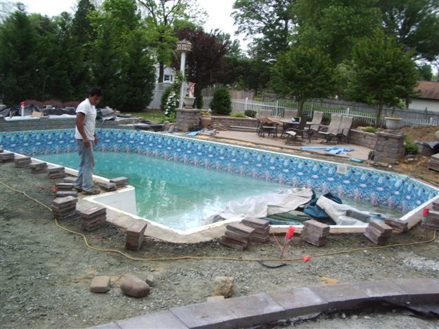 Großer Klassischer Pool hinter dem Haus in rechteckiger Form mit Wasserspiel und Pflastersteinen in Washington, D.C.