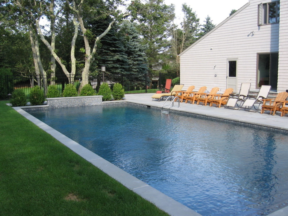 Immagine di una piscina naturale tradizionale personalizzata dietro casa con una vasca idromassaggio e pavimentazioni in pietra naturale