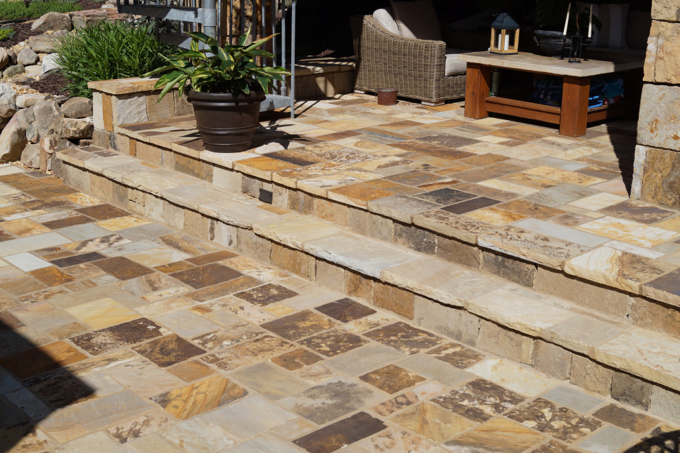 Inspiration for a large tropical backyard stone patio remodel in Atlanta