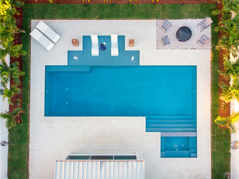 Example of a large minimalist backyard tile and rectangular lap hot tub design in Tampa