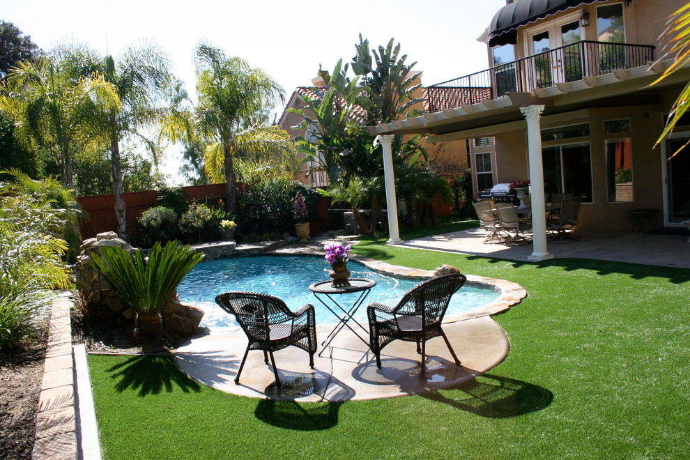 Example of a tuscan backyard pool design in Other