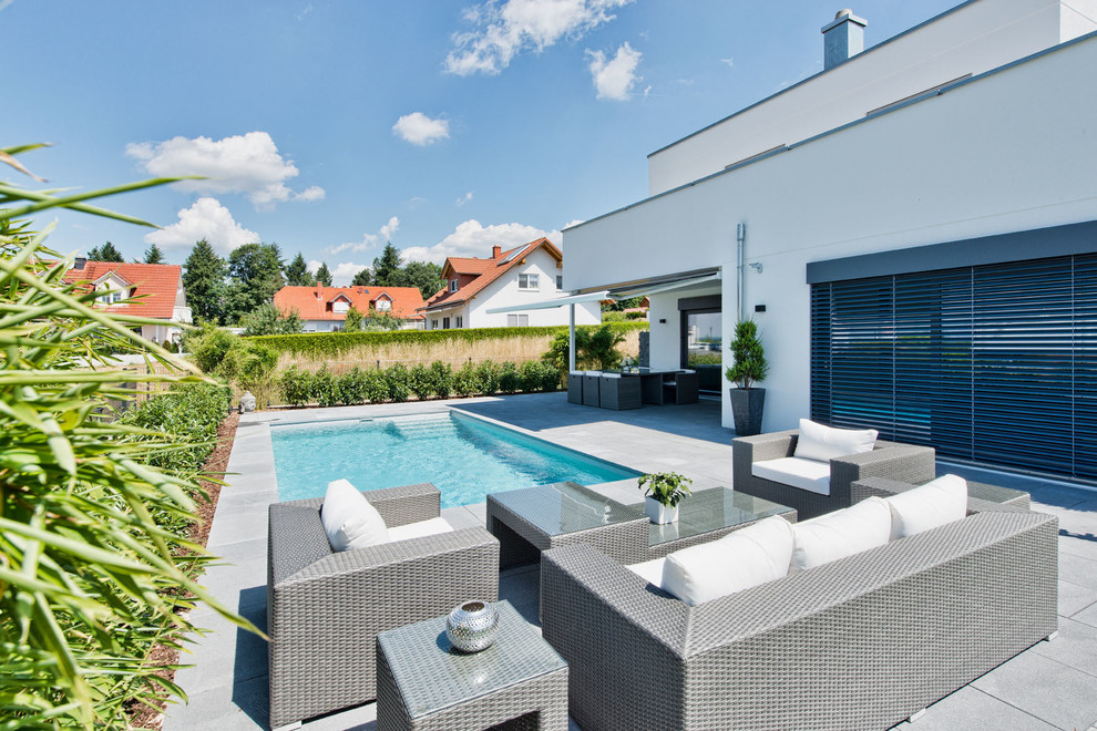 Mittelgroßer Moderner Pool hinter dem Haus in rechteckiger Form mit Betonplatten in Frankfurt am Main
