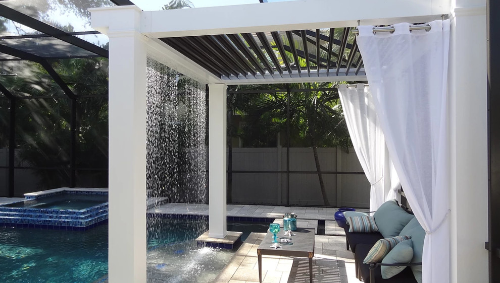 Hot tub - mid-sized tropical backyard stone and custom-shaped lap hot tub idea in Miami