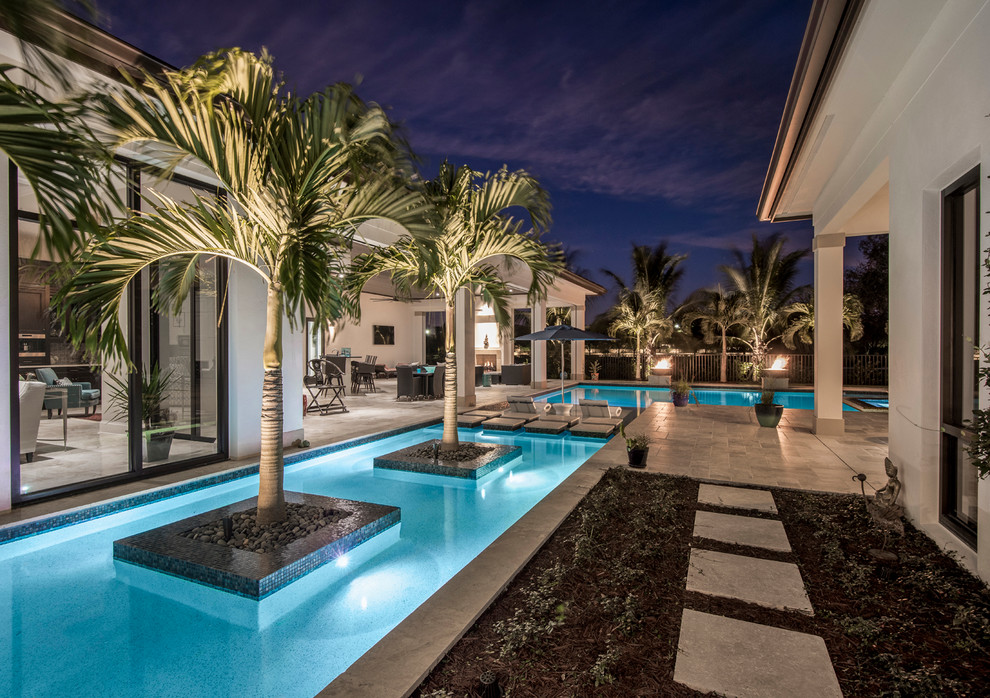 Pool fountain - large transitional backyard stone and custom-shaped pool fountain idea in Miami