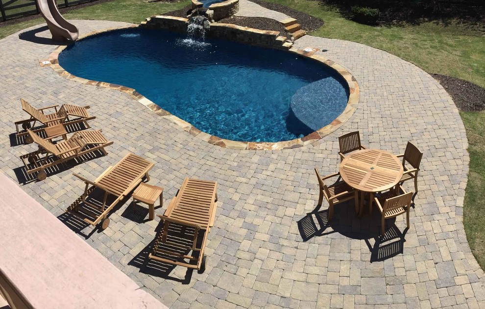 Mid-sized mountain style backyard concrete paver and kidney-shaped natural pool fountain photo in Atlanta