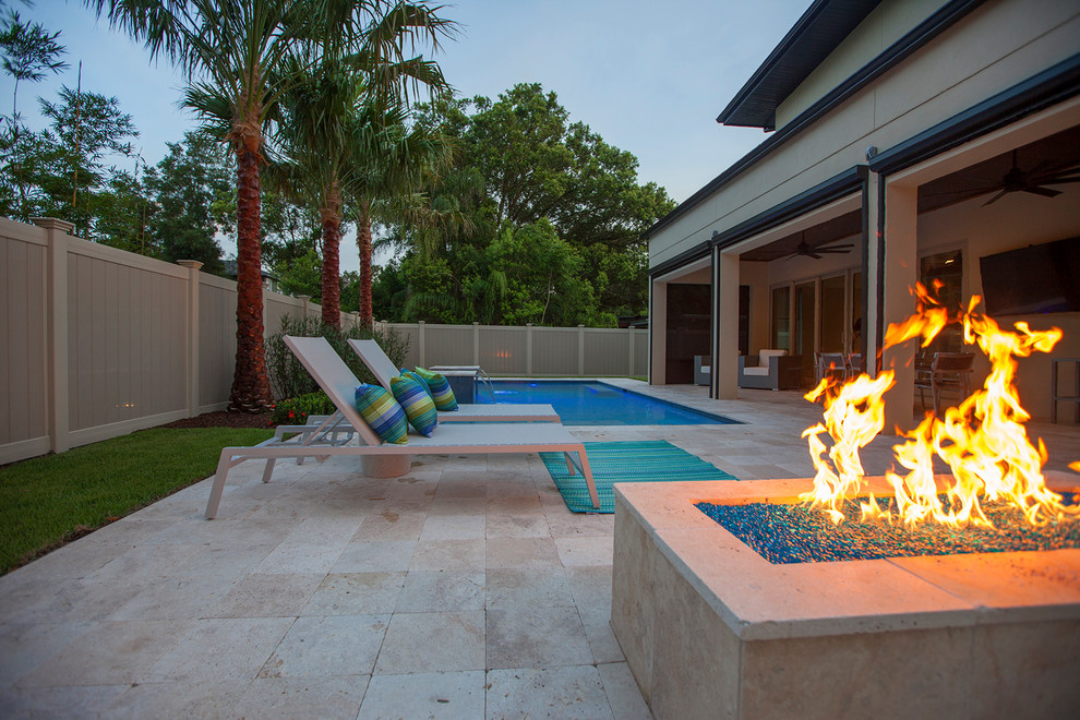 Pool fountain - mid-sized modern backyard stone and rectangular pool fountain idea in Orlando