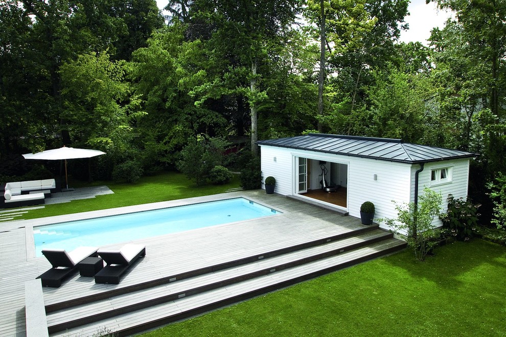 Idee per una grande piscina monocorsia minimal rettangolare dietro casa con una dépendance a bordo piscina e pedane