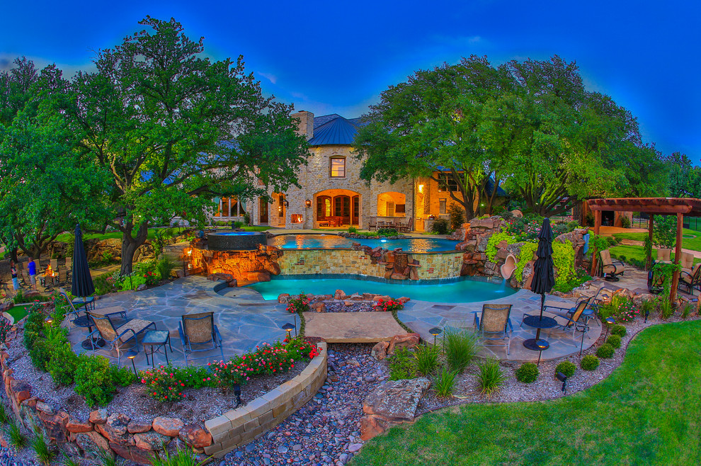 Inspiration for a huge timeless backyard stone and custom-shaped pool remodel in Dallas