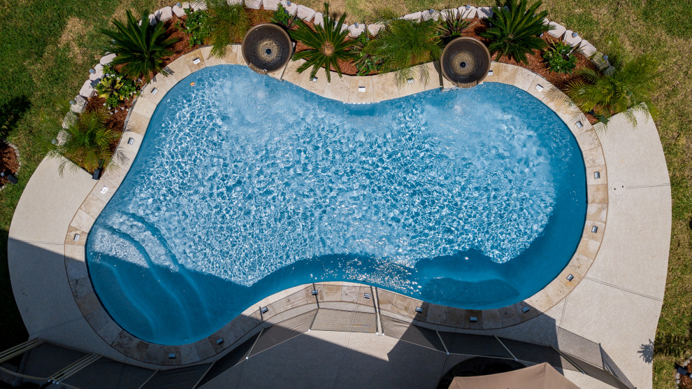Inspiration for a small world-inspired back kidney-shaped swimming pool in Houston.