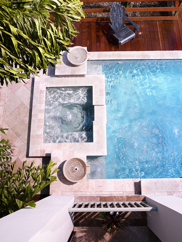 Inspiration for a medium sized world-inspired back rectangular lengths hot tub in Tampa with natural stone paving.