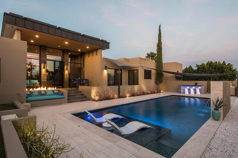 Idee per una grande piscina monocorsia design rettangolare dietro casa con fontane e piastrelle