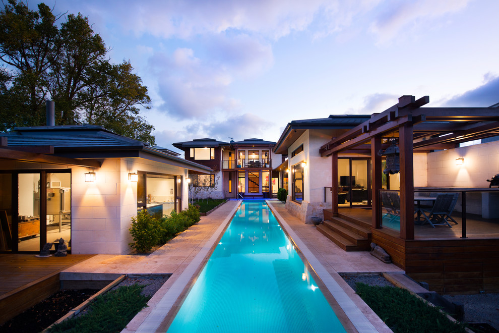 Inspiration for a contemporary backyard stamped concrete and rectangular pool remodel in Geelong