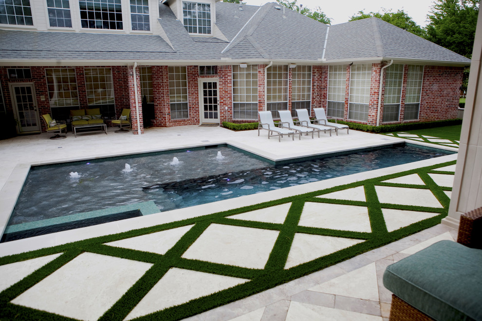Idee per una piscina classica a "L" con fontane e pavimentazioni in pietra naturale