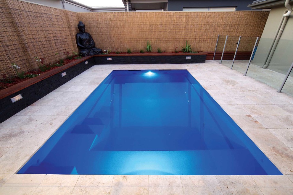 На фото: маленький прямоугольный бассейн в современном стиле с покрытием из каменной брусчатки для на участке и в саду с