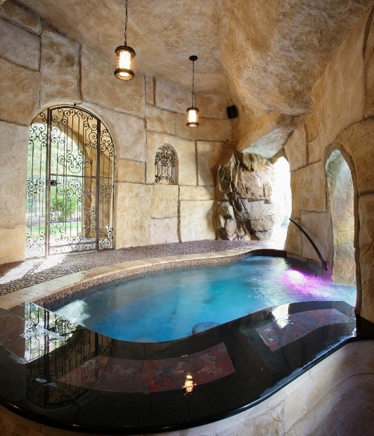 Design ideas for a mediterranean back custom shaped natural swimming pool in Houston.