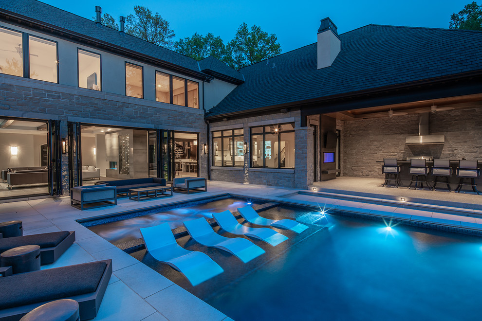 Inspiration for a contemporary courtyard rectangular pool remodel in St Louis