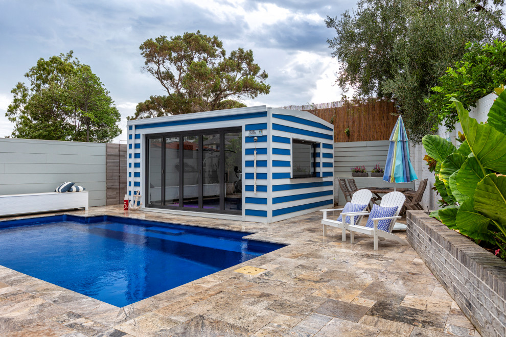Example of a mid-sized beach style backyard stone and rectangular pool design in Perth