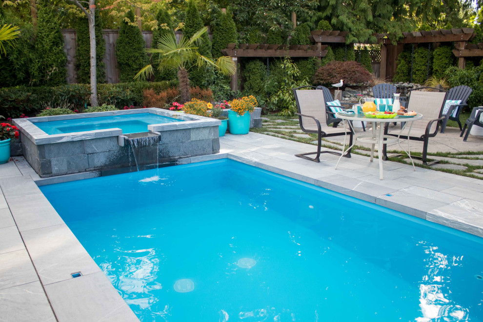 Inspiration for a mid-sized modern backyard stone and rectangular hot tub remodel in Vancouver