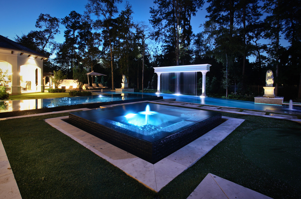 Example of a large tuscan backyard rectangular lap hot tub design in Houston