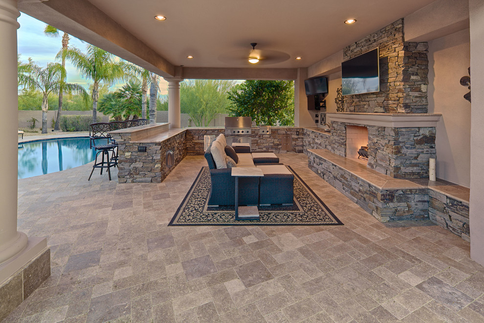 Example of a large tuscan backyard concrete paver patio design in Phoenix