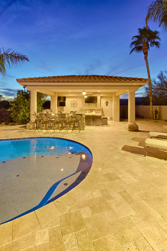 Design ideas for a large mediterranean back natural swimming pool in Phoenix with concrete paving.