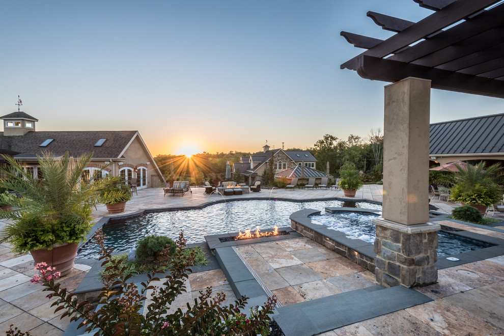 Large elegant backyard concrete paver and custom-shaped lap hot tub photo in Other