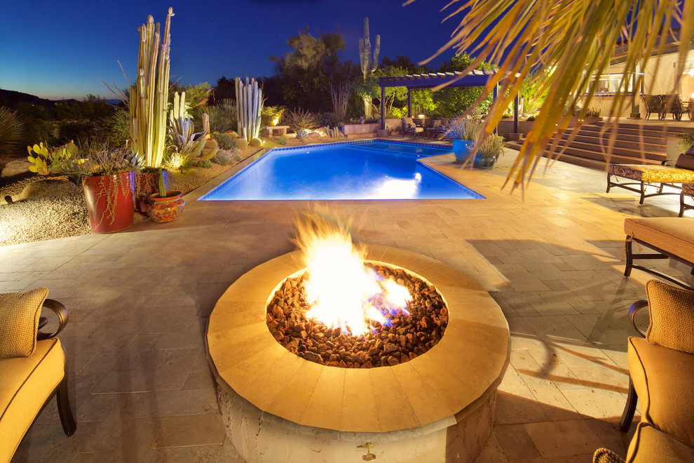 Large tuscan backyard concrete paver and custom-shaped natural pool photo in Phoenix