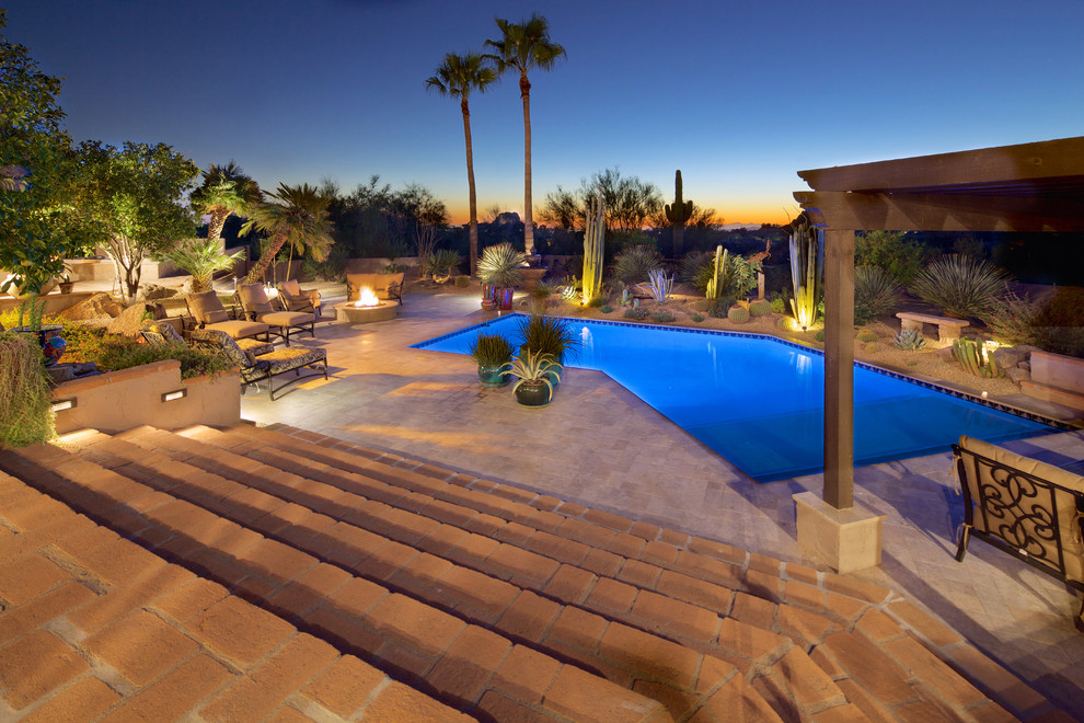 Foto de piscina natural mediterránea grande a medida en patio trasero con adoquines de hormigón